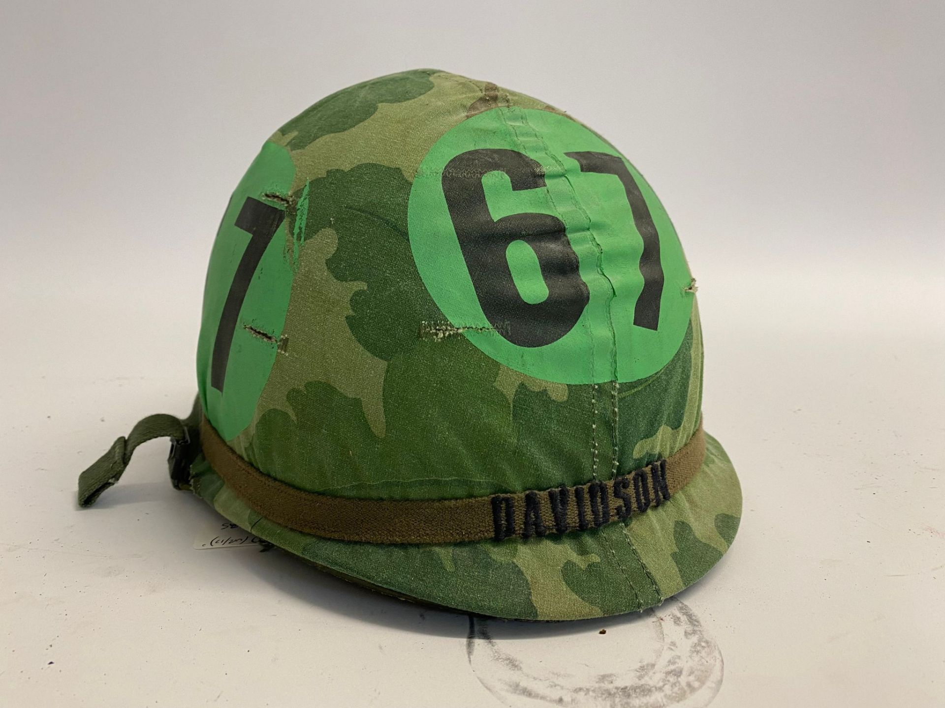 A US M1 airborne training helmet with embroidered band bearing the name Davidson.