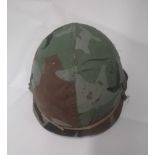 A 1980's US M1 helmet with liner and woo