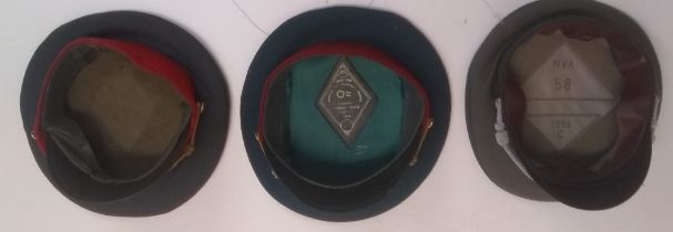 Three Eastern Bloc service caps.