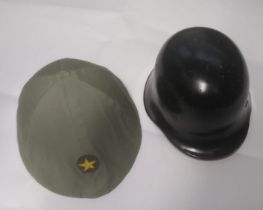 A North Vietnamese Army helmet, together