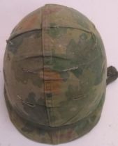 A Korean War era US M1 helmet with Vietn