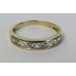 A 14ct gold half eternity ring set with nine cz stones being alternate princess and round cut in