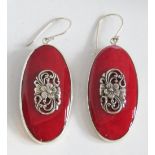 A large pair of silver and red stone earrings having art nouveau style floral panel to centre,