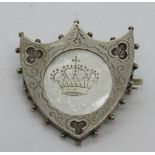 A hallmarked silver brooch in the form of a shield having central mother of pearl panel and clover