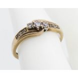 A 9ct gold ring having three central graduated round cut spinel in claw settings,