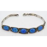 An articulated silver and opal cabachon bracelet,