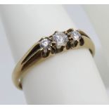 A 9ct gold ring having carved head set with three graduated round cut white cz stones,