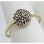 A 9ct gold diamond cluster ring, four layer in white metal totaling 0.