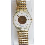 A Swatch Flex watch in Golden Waltz pattern, original packaging, new battery within box.