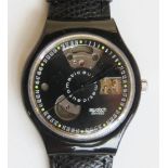 An automatic Swatch watch in Black Motion pattern, within original packaging.