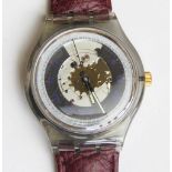 An automatic Swatch watch in Rubin pattern, within original packaging.