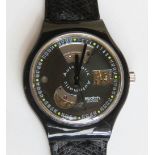 An automatic Swatch watch in Black Motion pattern, within original packaging.