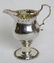 A George III hallmarked silver jug having beaded rim and foot, standing 10.5cm high, 85.5g / 2.