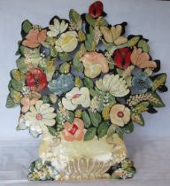 A large handpainted metal screen in the form of an abundant bouquet, signed Nobert A, 93cm high.