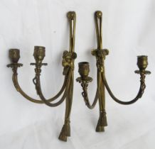 A pair of brass wall candle sconces each with Rams head to centre.