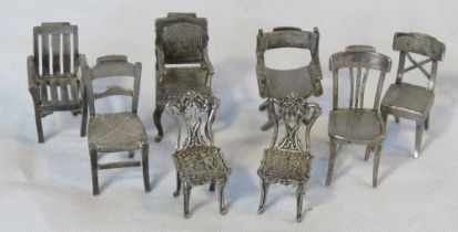 A pair of 925 silver miniature dining chairs,