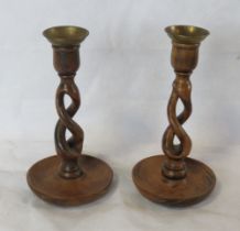 A pair of carved wooden candlesticks.