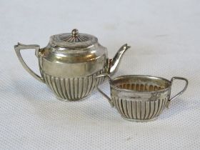 A miniature 925 silver teapot and sugar bowl.