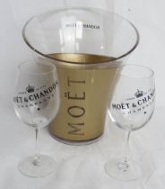 A Moet & Chandon champagne ice bucket together with a pair of glasses.