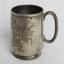 A hallmarked silver tankard having floral engraving throughout, approx 8.5cm high, 114.6g / 3.69ozt.