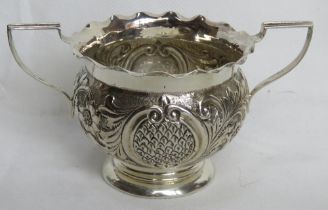 A hallmarked silver twin handled bowl having repoussé decoration throughout, 13cm wide, 80.2g / 2.