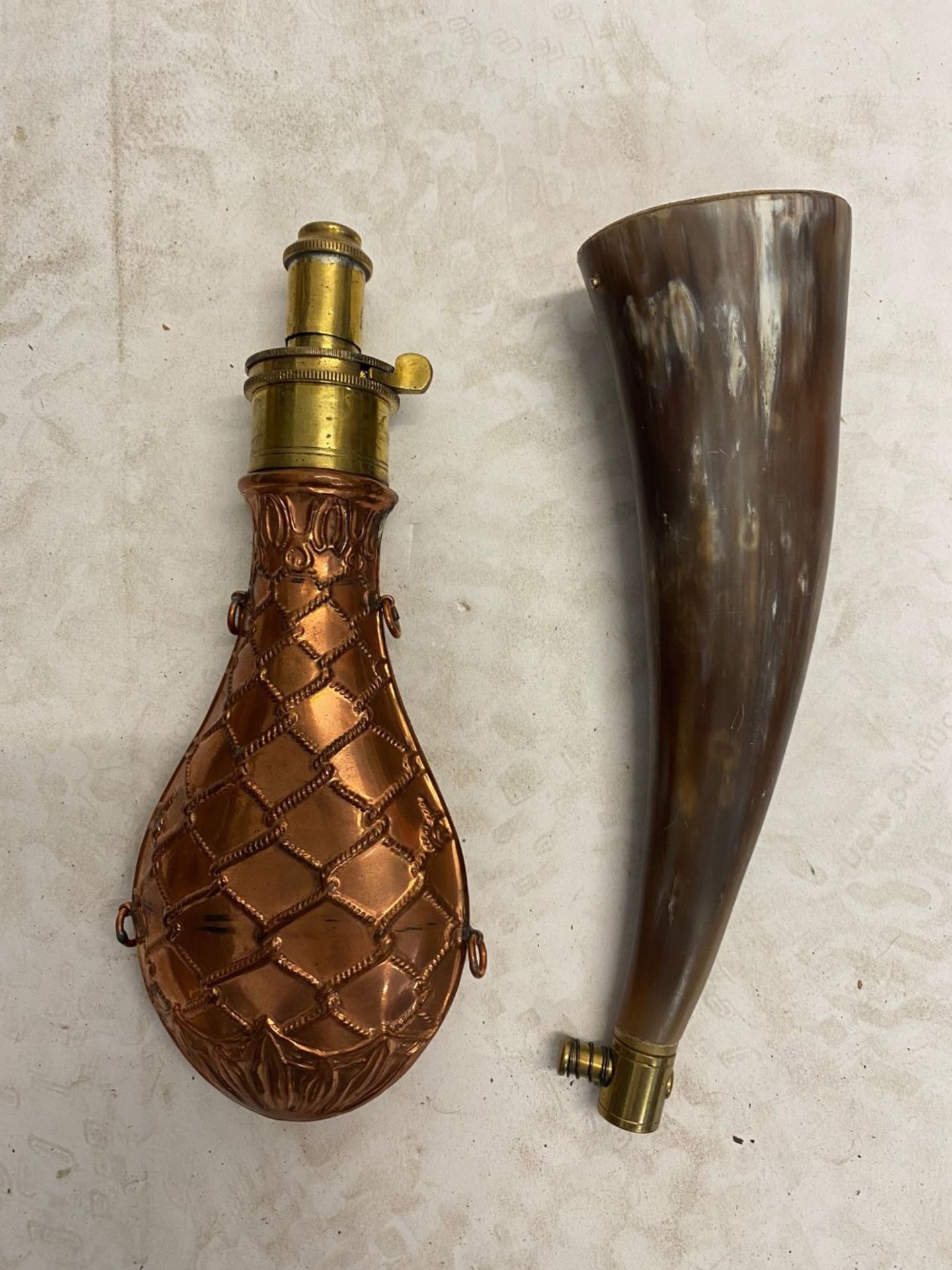 A copper powder flask and a horn powder