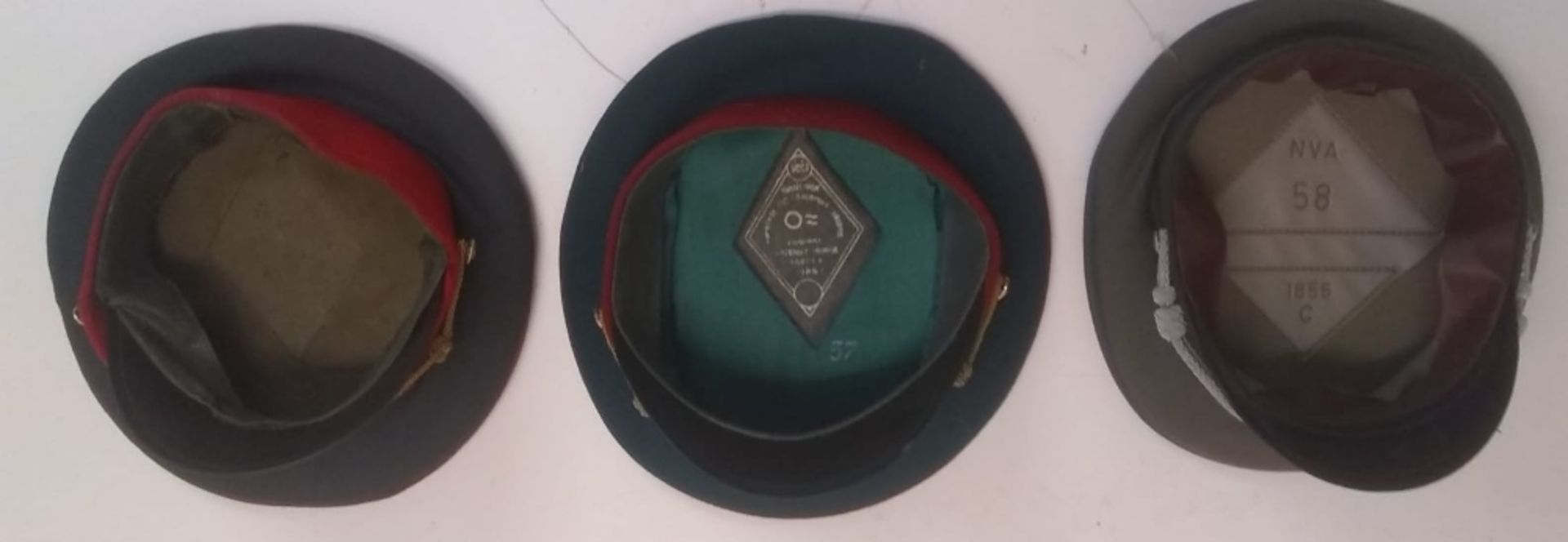 Three Eastern Bloc service caps. This