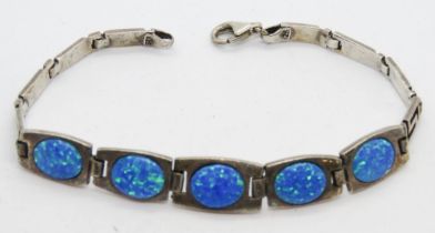 An articulated silver and opal cabachon bracelet,