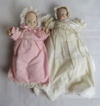Two baby dolls, one marked sugar lump to the back of the head.