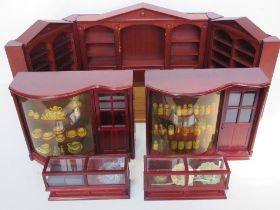 Two shop front type dolls house displays together with two dolls house shop counters,