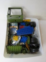 A small quantity of assorted Meccano inc wheels, Army green vehicle parts, etc.