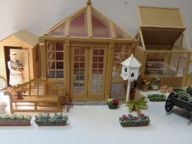 A dolls house garden set comprising shed, orangery and greenhouse,