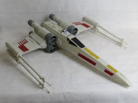A Star Wars model X wing fighter.