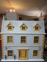 A 'Victorian Manor' dolls house with dining room, sitting room, nursery with child,