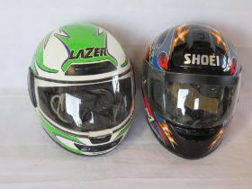 Two contemporary motorbike helmets, for decorative use only.