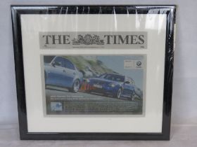 A framed BMW themed newspaper article.