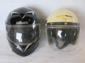 Two contemporary motorbike helmets, for decorative use only.