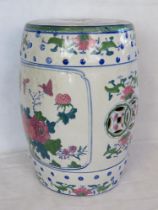 A Chinese style ceramic stool, white ground with pink butterflies upon.