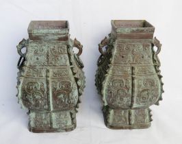 A pair of Oriental bronze lamp bases in the archaic style of square baluster form,
