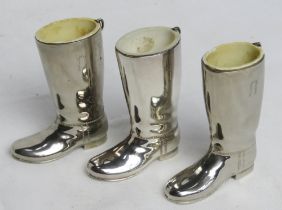 Three silver plated riding boot themed tot cups.