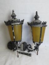 A pair of black painted cast metal outdoor wall lights.