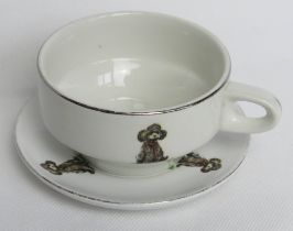 A delightful duck and Poodle type dog themed teacup and saucer, cartoon style images,