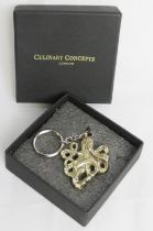 An as new in box Culinary Concepts octopus pattern keychain.