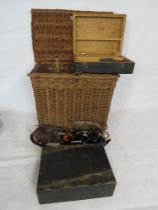 A vintage wicker fishing creel containing a number of angling accessories including a Mitchell 304