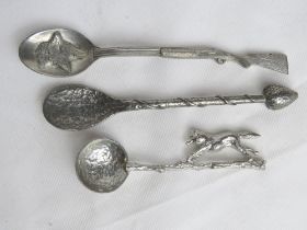 Three spoons, one with strawberry design, two with fox designs.