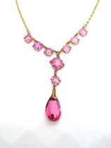 An early 20th century pink paste stone necklace, stamped 9ct to the clasp,