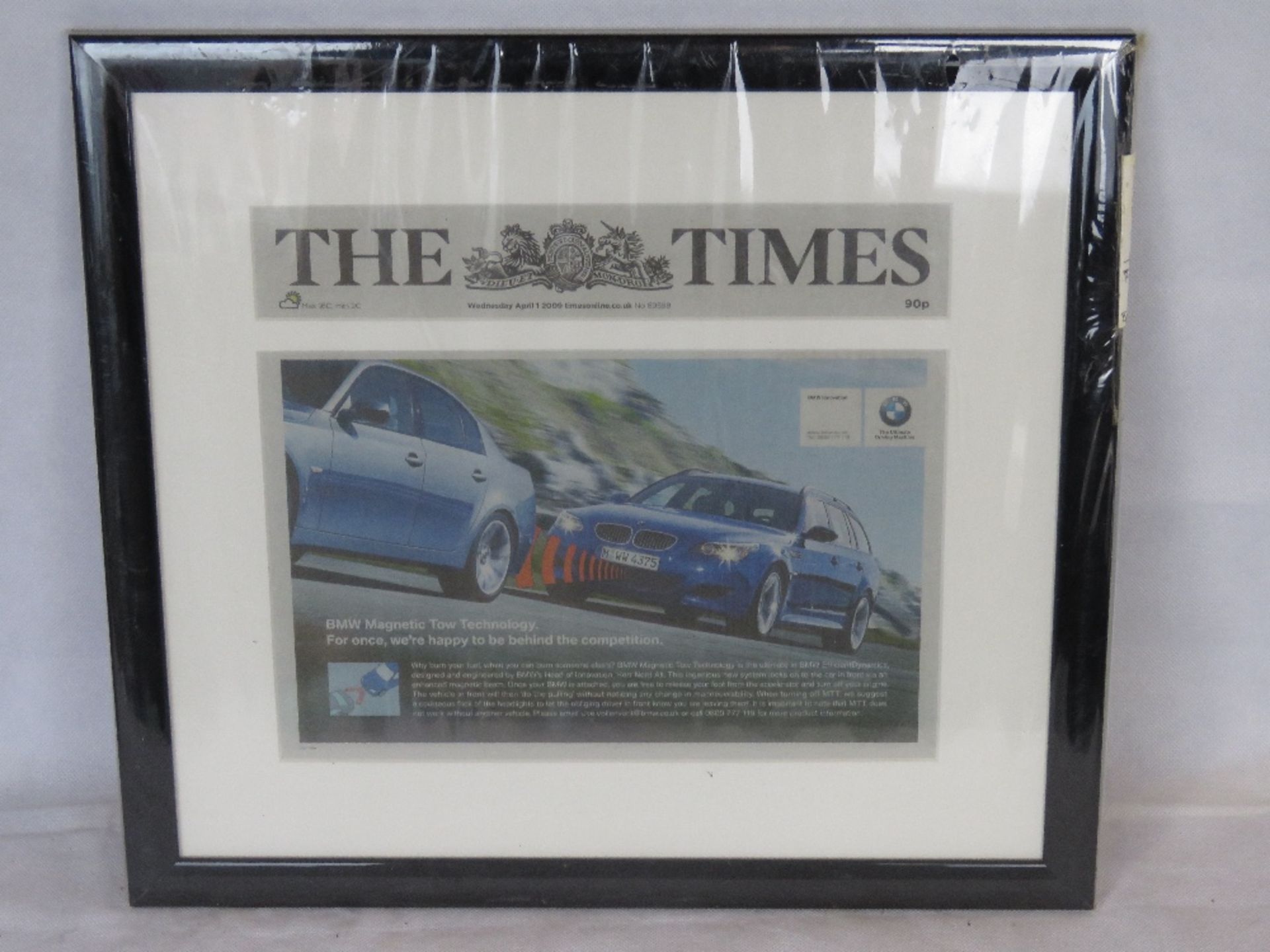 A framed BMW themed newspaper article.