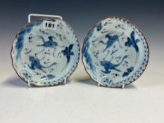 A PAIR OF JAPANESE ARITA BLUE AND WHITE SHALLOW BOWLS, EACH PAINTED WITH TWO CRANES FLYING AMONGST