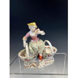 A 19th C. GERMAN DOUBLE SWEETMEAT WITH THE FIGURE OF A LADY SEATED BETWEEN THE TWO BASKETS ABOVE THE