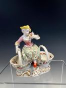 A 19th C. GERMAN DOUBLE SWEETMEAT WITH THE FIGURE OF A LADY SEATED BETWEEN THE TWO BASKETS ABOVE THE